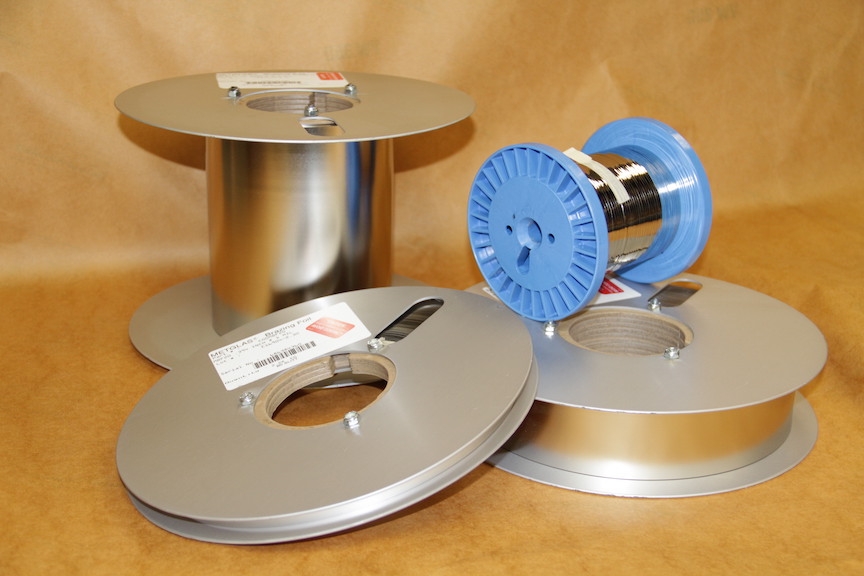 Various sizes of brazing foil rolls on brown paper background